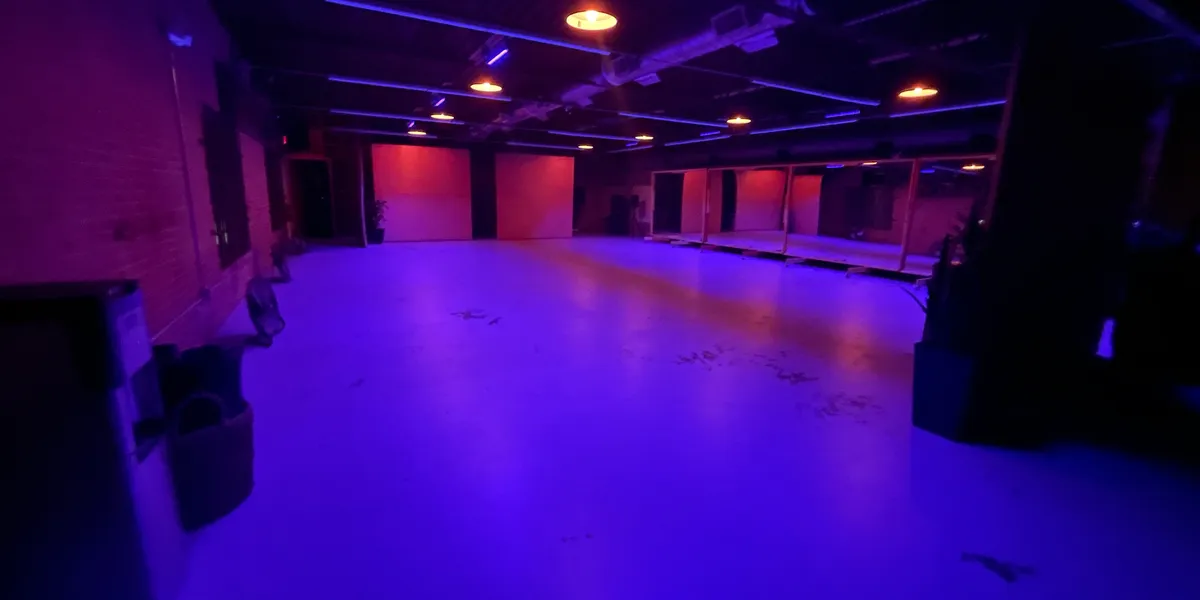 Space512 at night — moody purple event lighting across the open floor